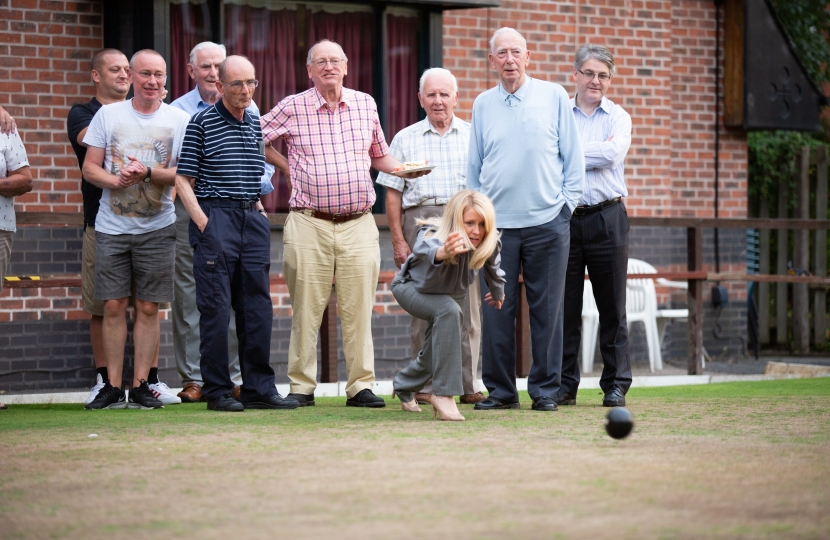 Esther tries her hand at bowling on the club's Green